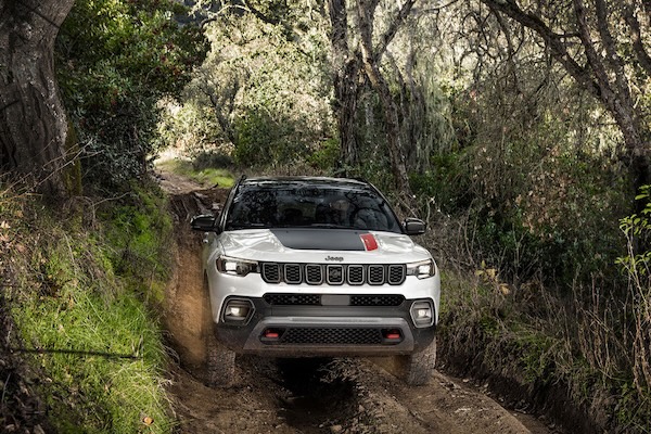 A 2025 Jeep Compass offroading in the woods.
